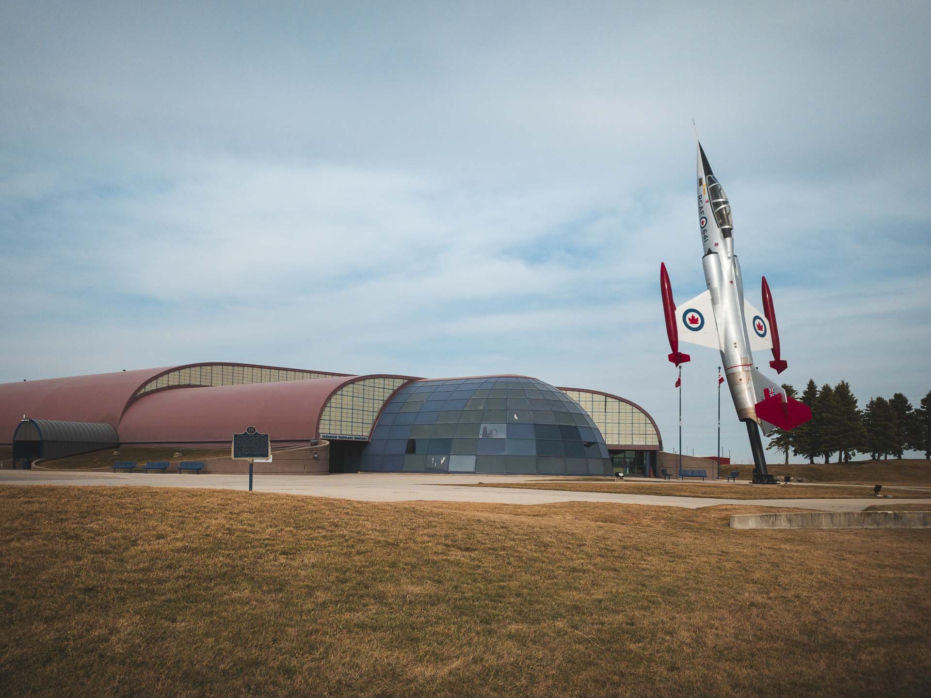 Exterior of the canadian warplane heritage museum with a Canadian fighter jet out front.