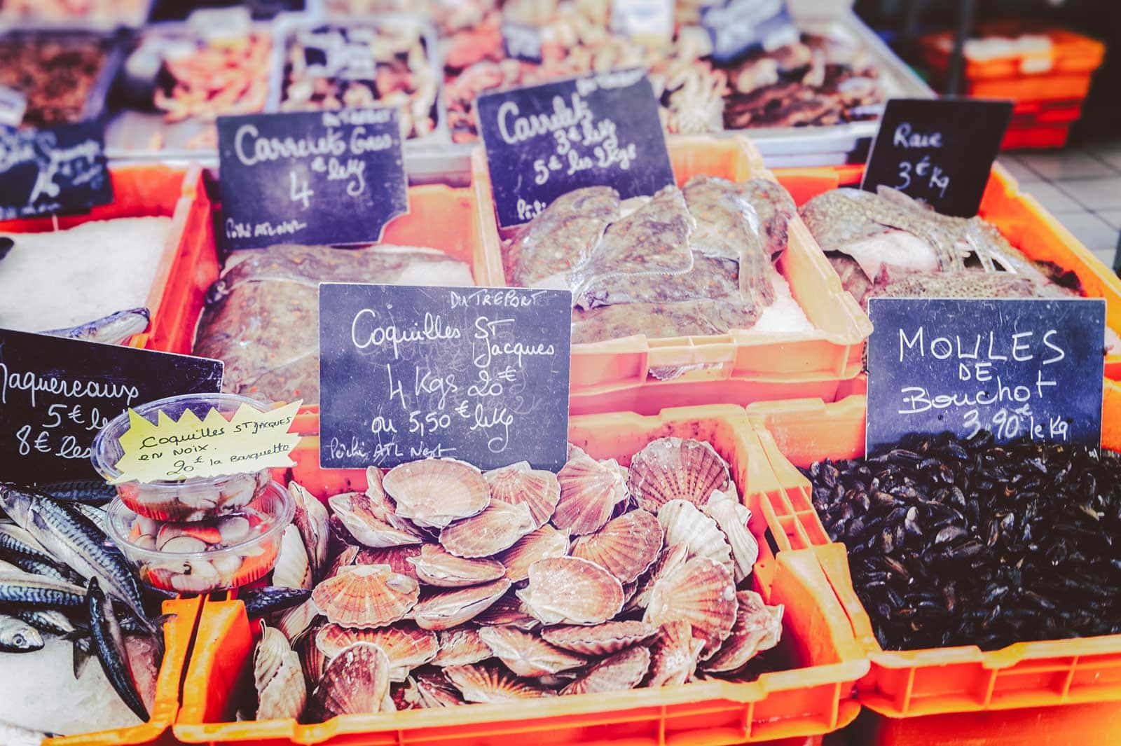 A classic French dish of Coquilles Saint-Jacques, featuring scallops in a market in Normandy