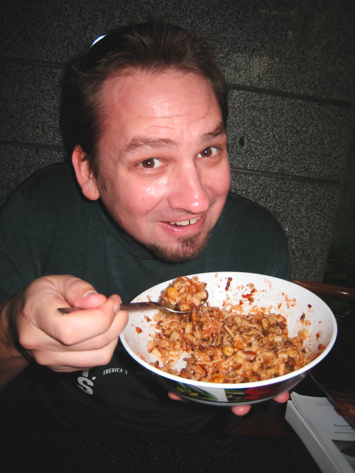 Dave from The Planet D enjoying a A delicious-looking, freshly cooked bowl of Koshari, a safe and popular street food dish to eat in Egypt.