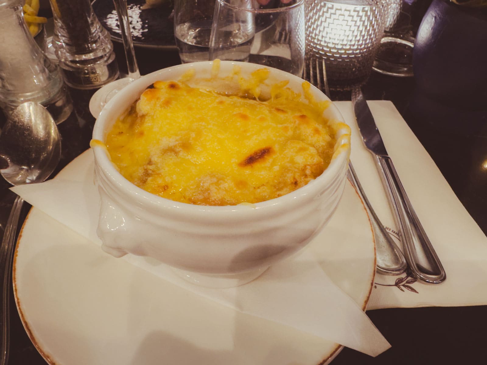 The steaming bowl of French onion soup with a thick cheese crust that we ate on a rainy day in a Parisian bistro