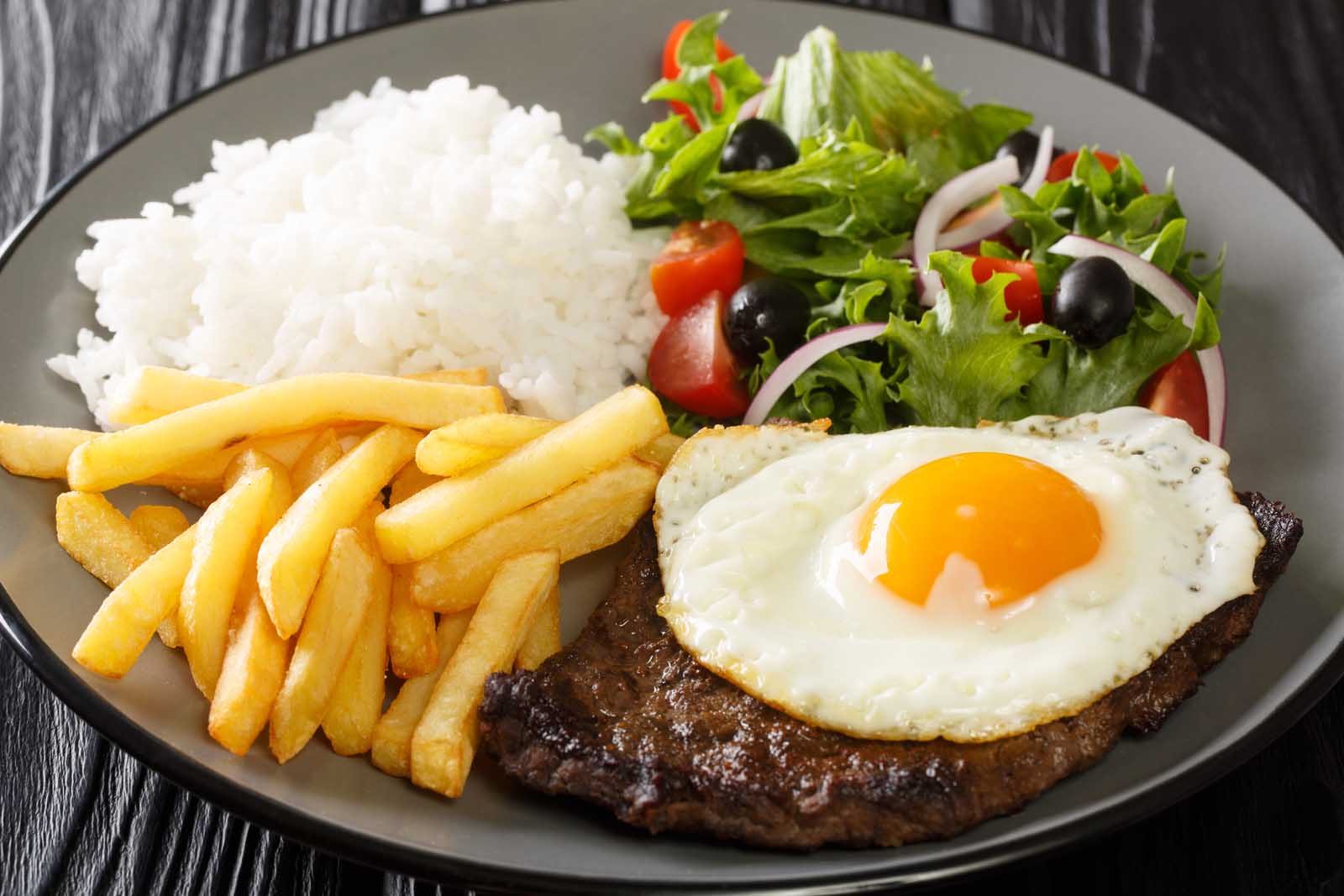 A classic Bitoque steak topped with a perfect fried egg, a staple of Portuguese cuisine.
