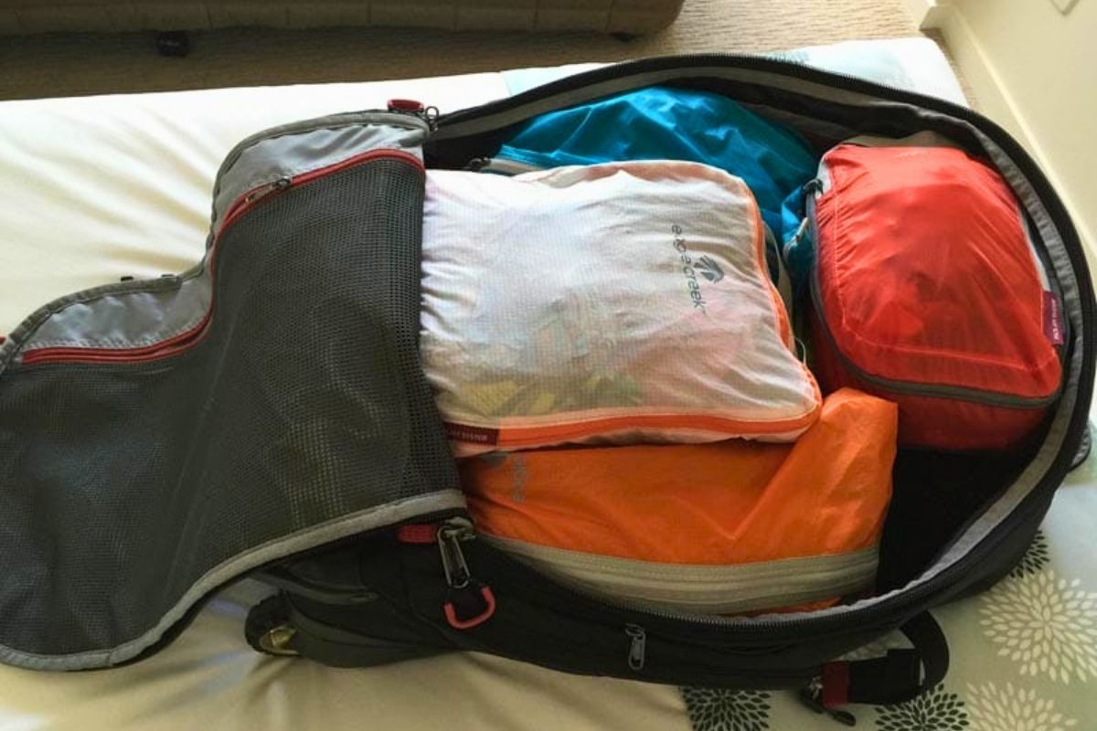 Open suitcase with packing cubes showing why travelers should photograph the inside of their checked luggage before flying.