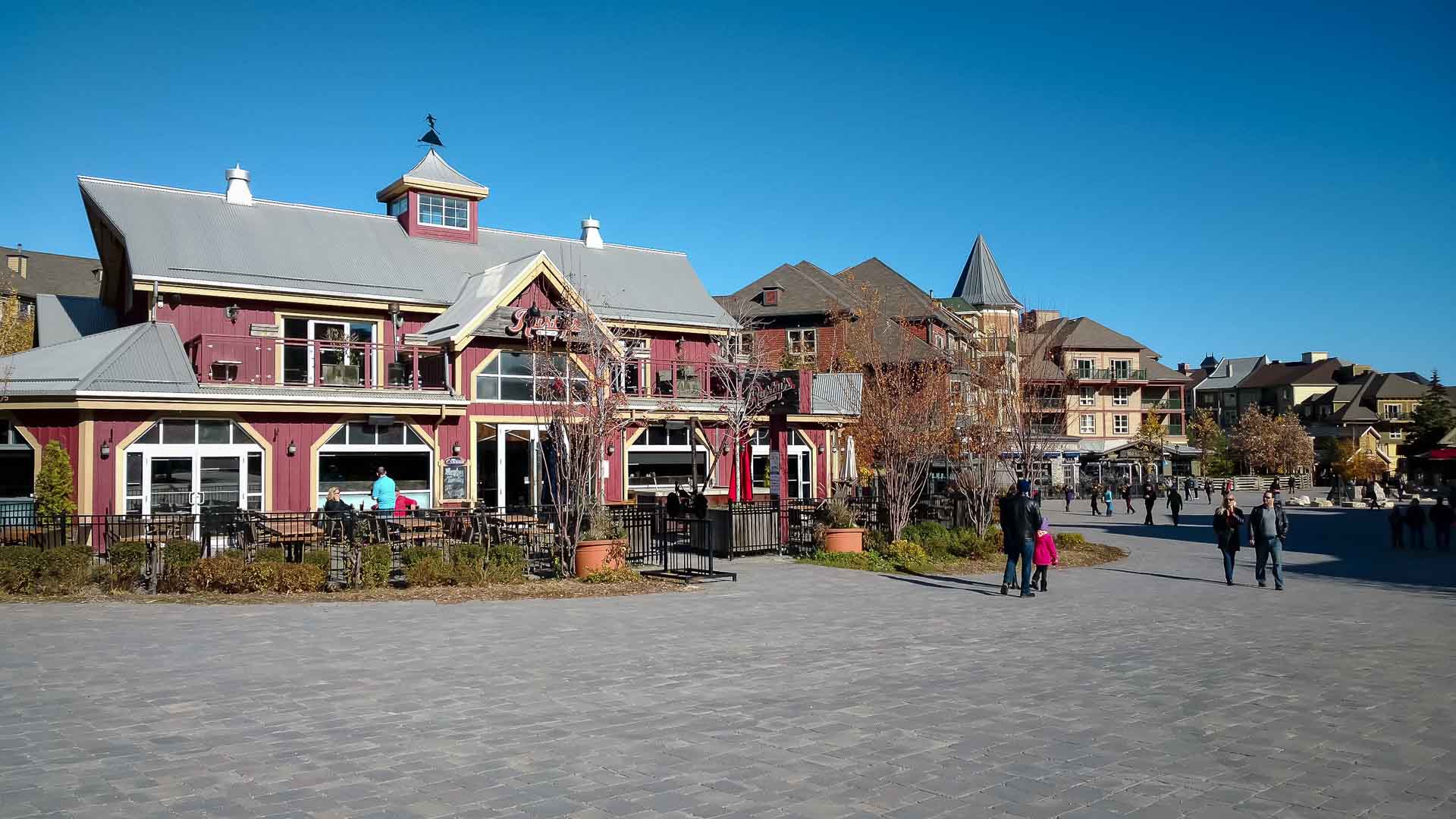 Summer day at Blue Mountain Village with visitors walking through